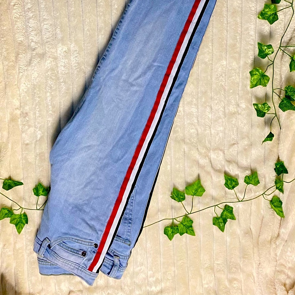 Blue jeans with black, white, and red stripes
